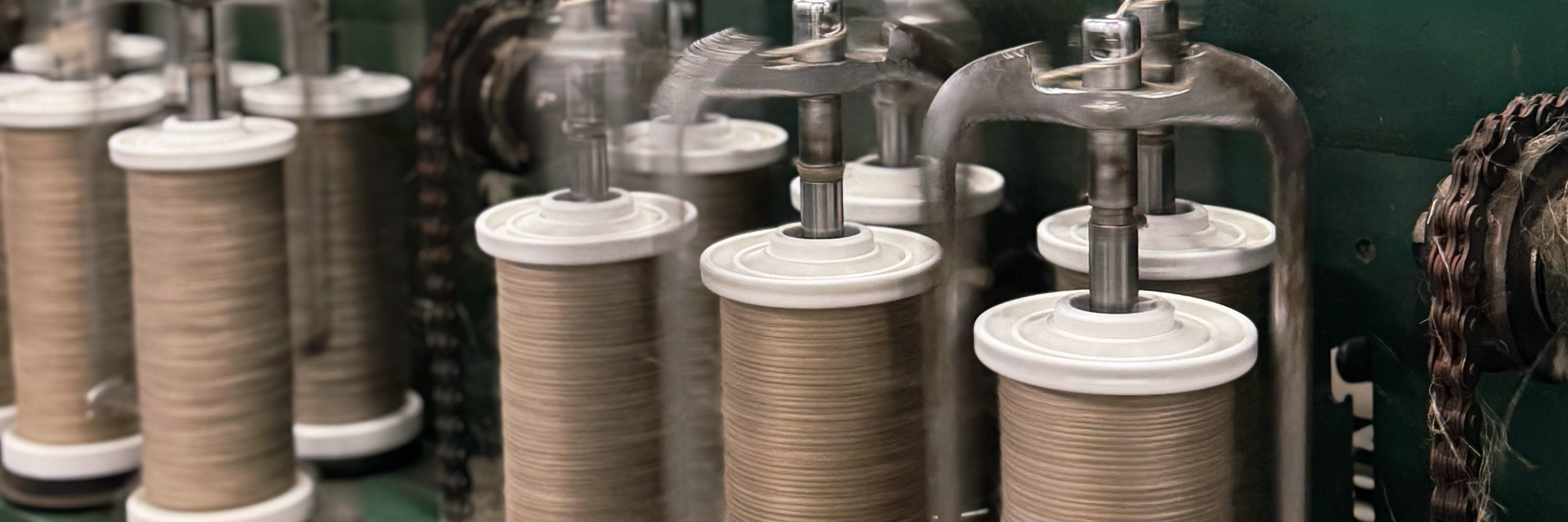 Wet-spun linen yarn in natural color on industrial bobbins